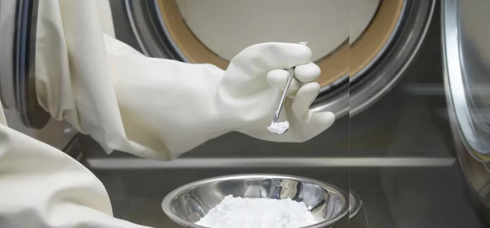  Gloved handling of pharmaceutical sample inside a controlled environment chamber for laboratory testing