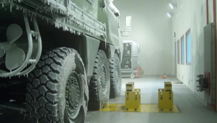 Environmental simulation testing of a military vehicle under controlled climate and load conditions in a defence environment
