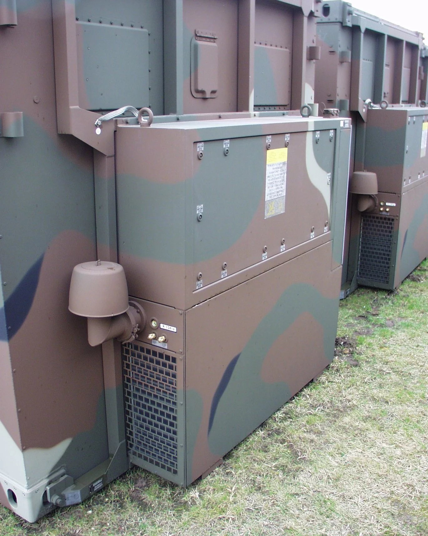  Tactical TKA air conditioning units from Weiss Defence mounted outdoors on military containers.
