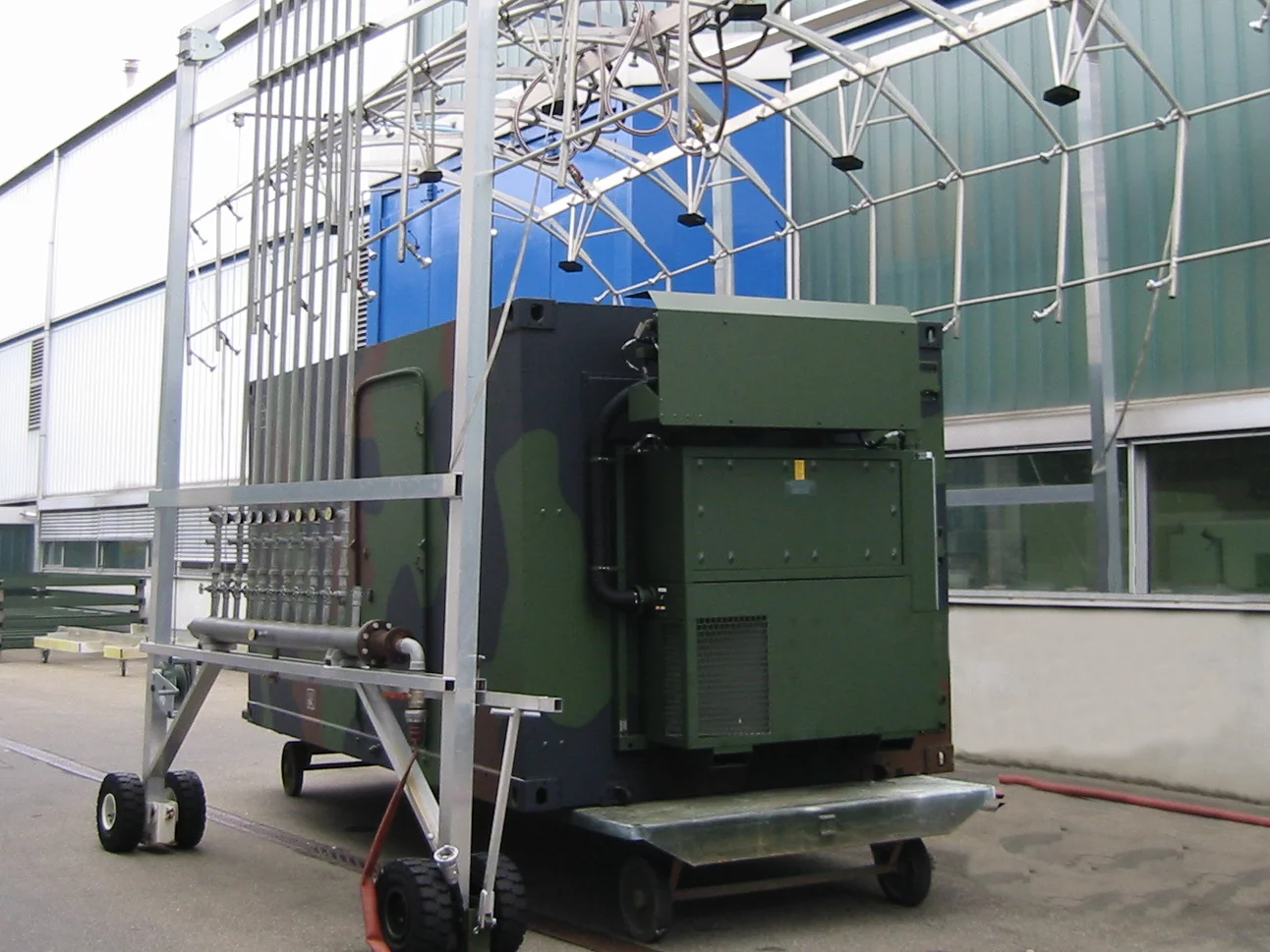  Tactical TKA series air conditioning unit from Weiss Defence on a transport trolley during an outdoor technical test setup.
