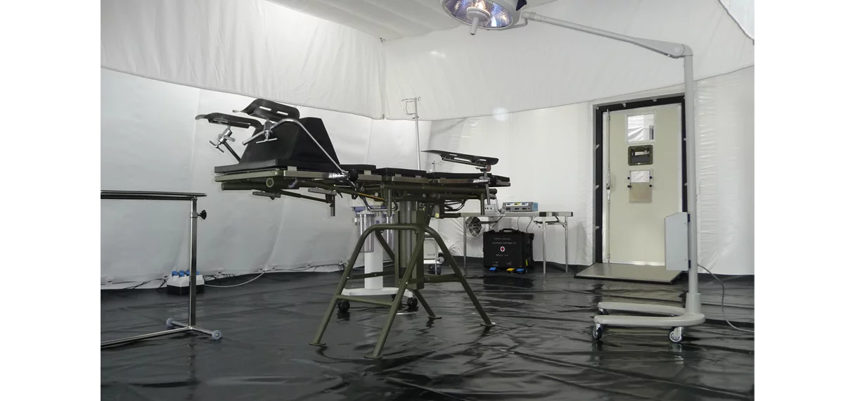  Interior view of a mobile cleanroom tent with operating table and medical equipment for clinical use