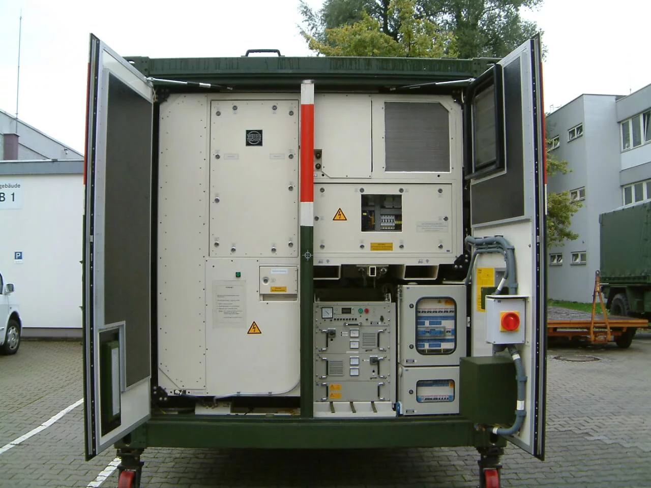  Installed HKE10 hygienic climate compact unit by Weiss Defence inside an open shelter with control systems and technical components