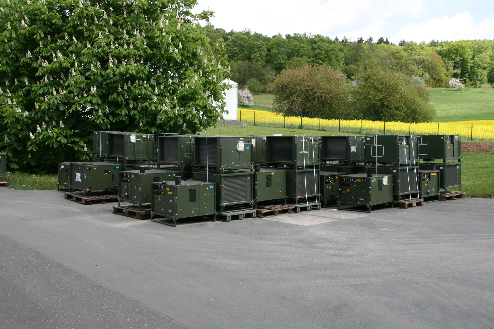  Multiple climate units of the ZKB 15/10 MFA mobile tent climate system by Weiss Defence on pallets outdoors