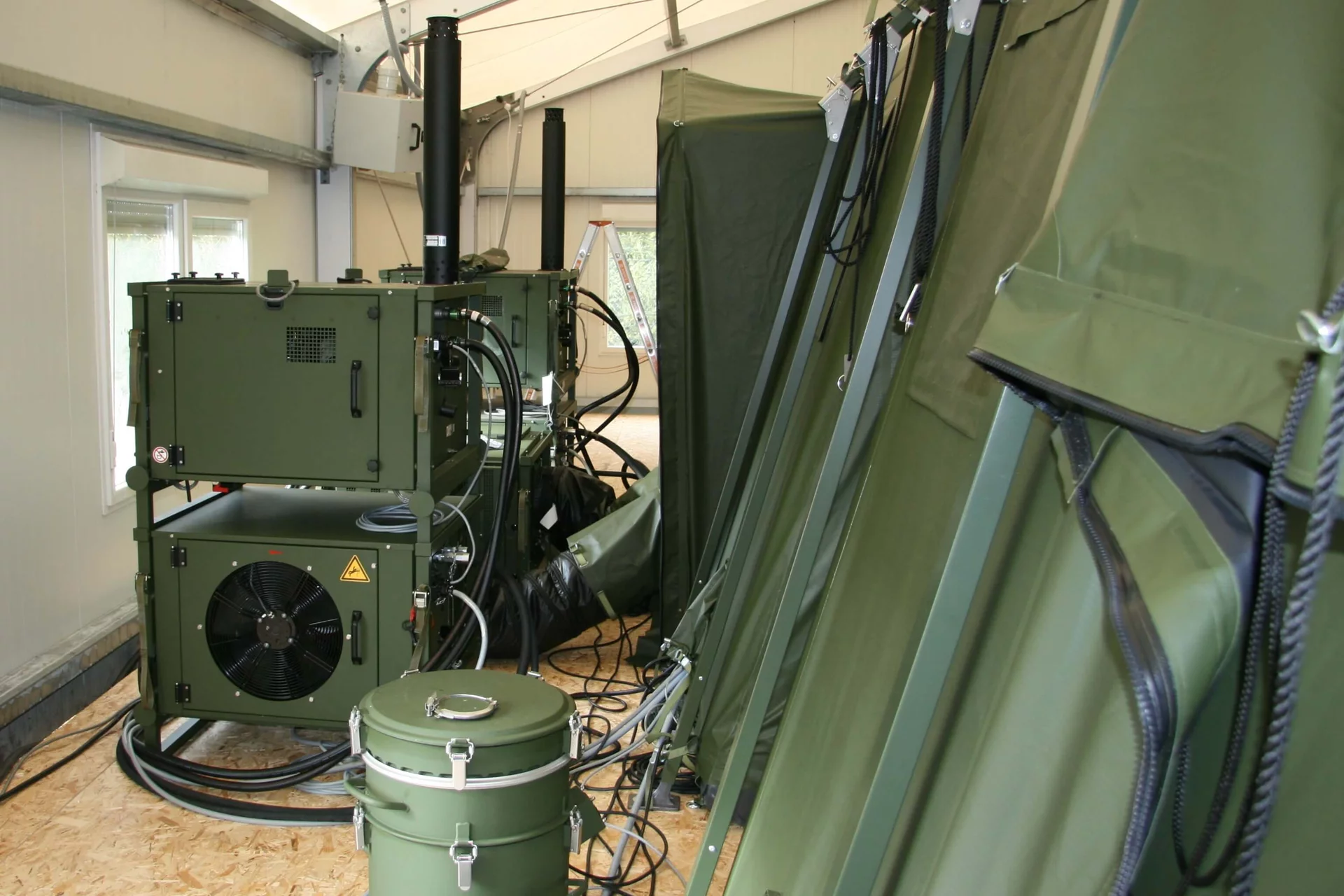 Installed ZKB MCRS1 tent climate system by Weiss Defence with modular units, air hoses and exhaust pipes