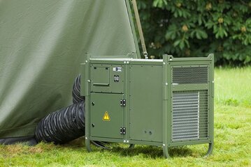 Mobile military Module‑R tent air conditioning unit by Weiss Defence in field operation next to an operational tent.
