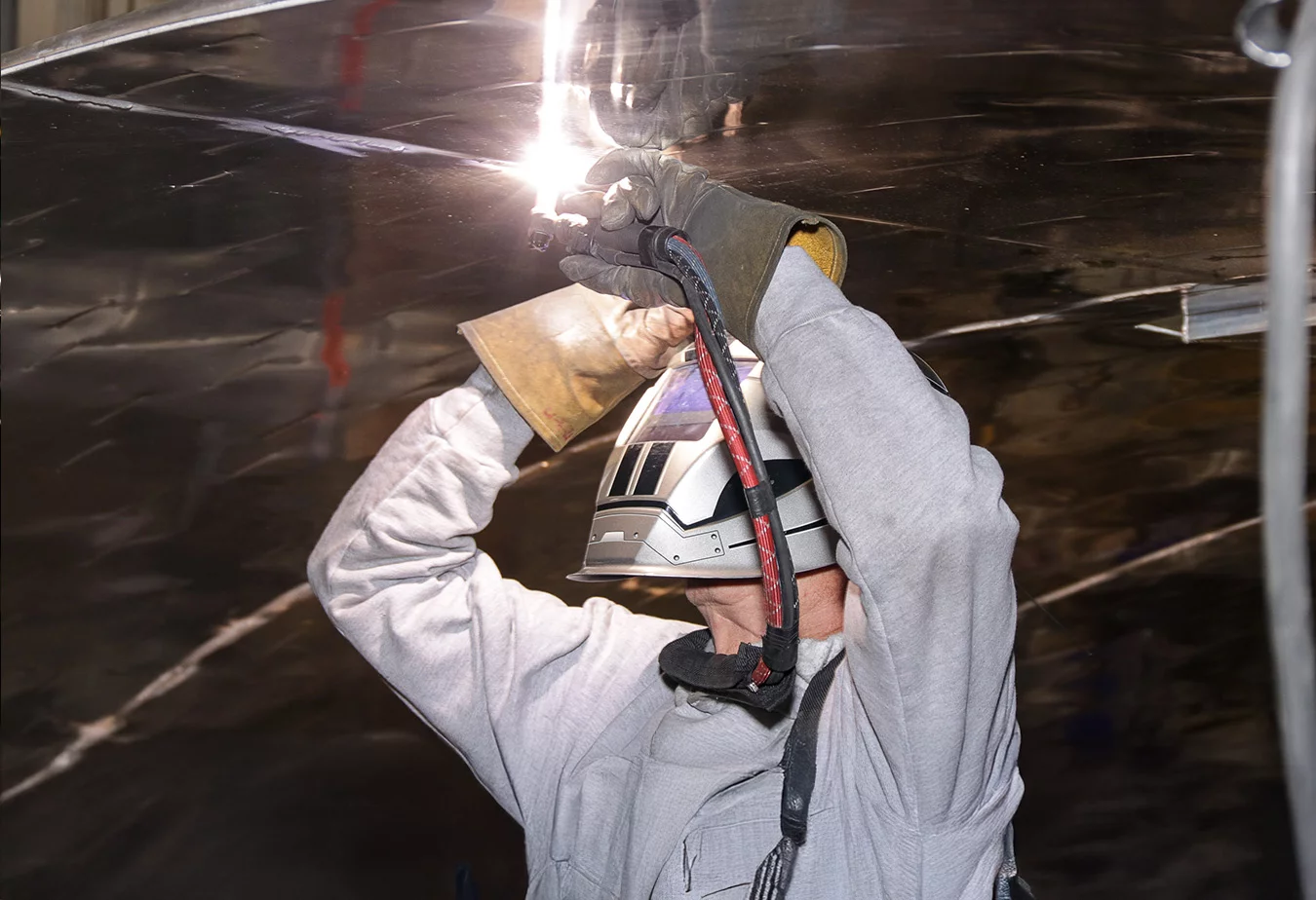 Precision welding work on metallic structures inside a space simulation test chamber