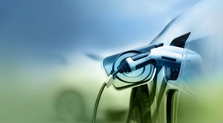 Electric vehicle charging cable connected to car representing e‑mobility and sustainable technology